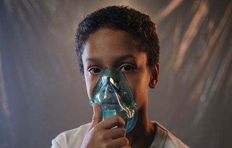 Boy wearing oxygen mask