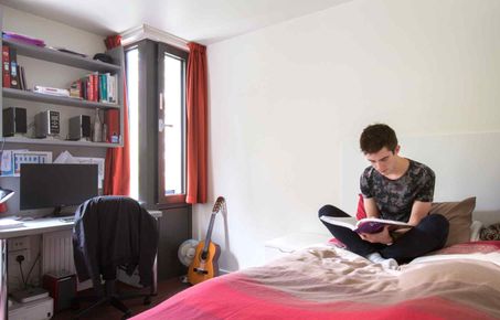 A student in his room in halls