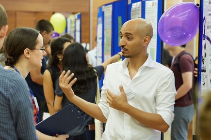 PhD student presenting poster