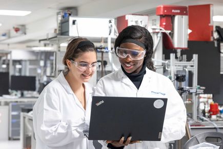 Two students looking at computer