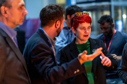 A woman and man in discussion at an event