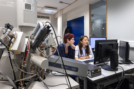 Two female researchers looking at a computer screen