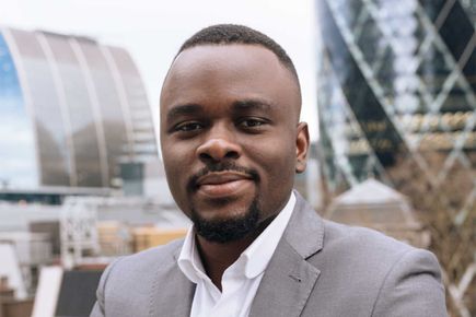 Portrait of Emmanuel Igbinovia smiling at the camera