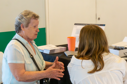 Two women discussing research on a table