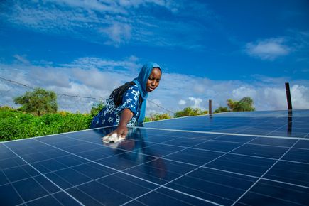 Woman cleaning a solar panel