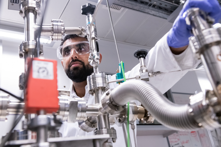 A researcher adjusting a piece of equipment