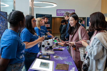 Materials researchers doing a demonstration at an outreach event