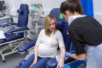 A picture of a nurse carrying out a blood test on a pregnant woman