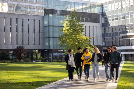 Students walking near library in autumn