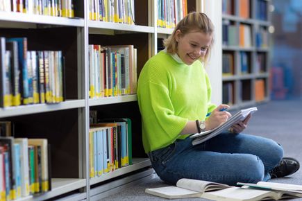 Student reading in the library