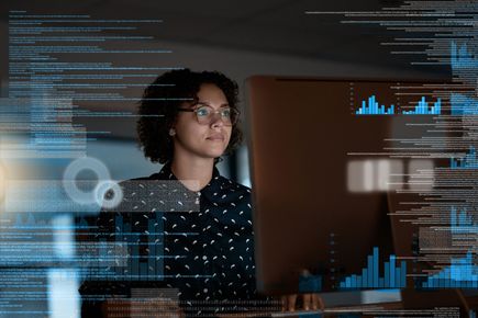 A picture of a woman looking at a digital screen