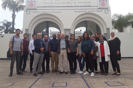 People stand in front of arch