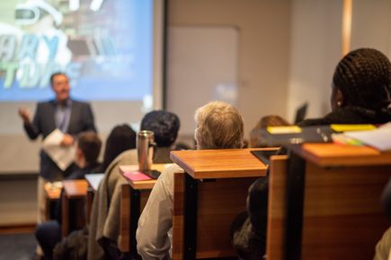 Group of people listening to a speaker