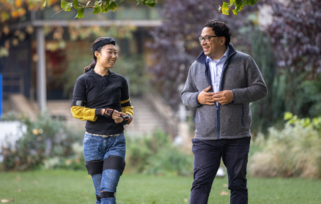 two researchers walking on grass