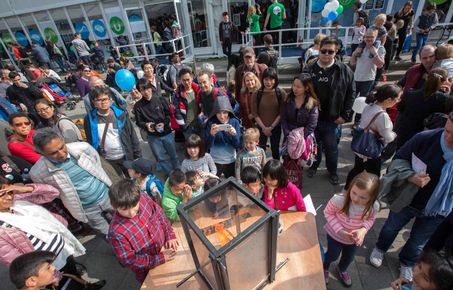 Members of the public look at a scientific demonstration at Imperial Festival.