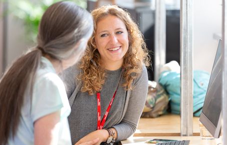 Student talking to a member of staff