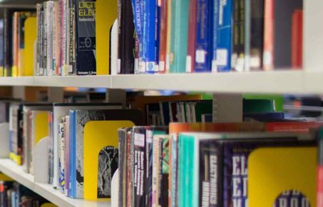 Shelf of books in library showing their spines