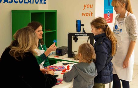 An NIHR HPRU colleage explaining vascular structures to children at an outreach activity