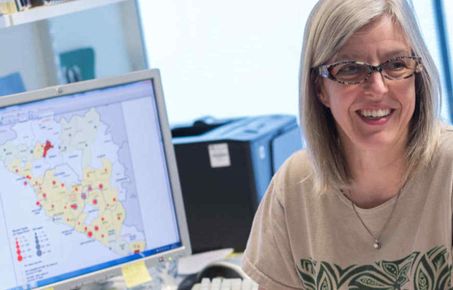 Professor Christl Donnelly working at her desk