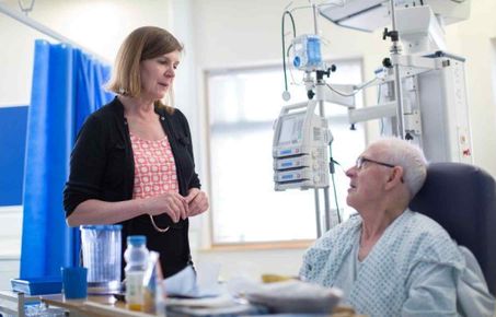 Hospital staff talking with patient