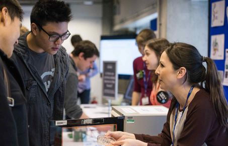 Picture of staff demonstrating their research to colleagues