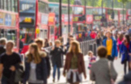 A shot of people walking in front of London buses