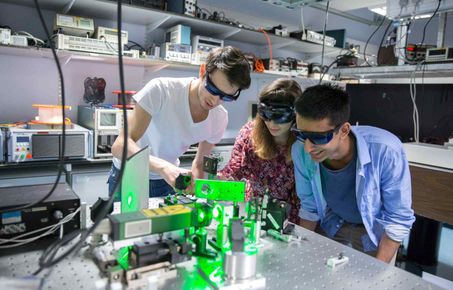 Physics students working with lasers in the Blackett Lab