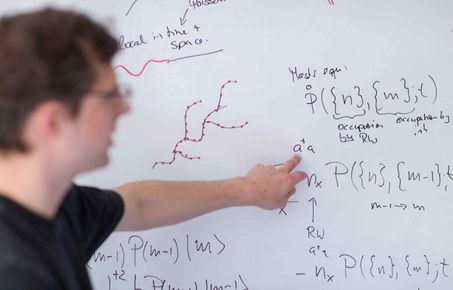 Student explaining concept on a whiteboard