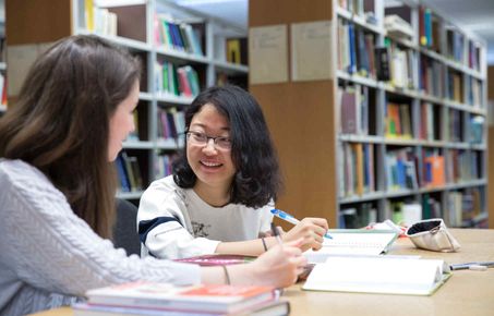 Two students reading a book
