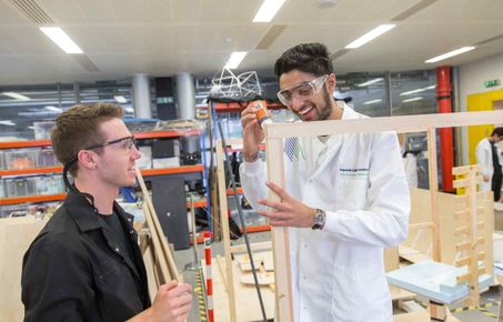 Two students building a wooden frame