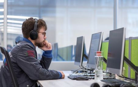 Male student looking at desktop computer