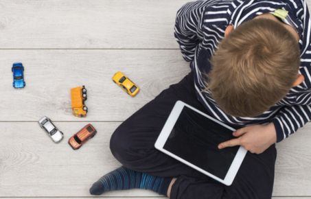 child playing on tablet