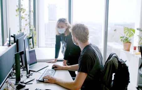 Two colleagues working together in an office