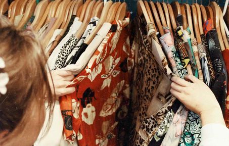 A women looking through a clothing rack