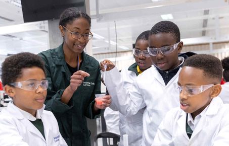 Staff showing students around the laboratory 