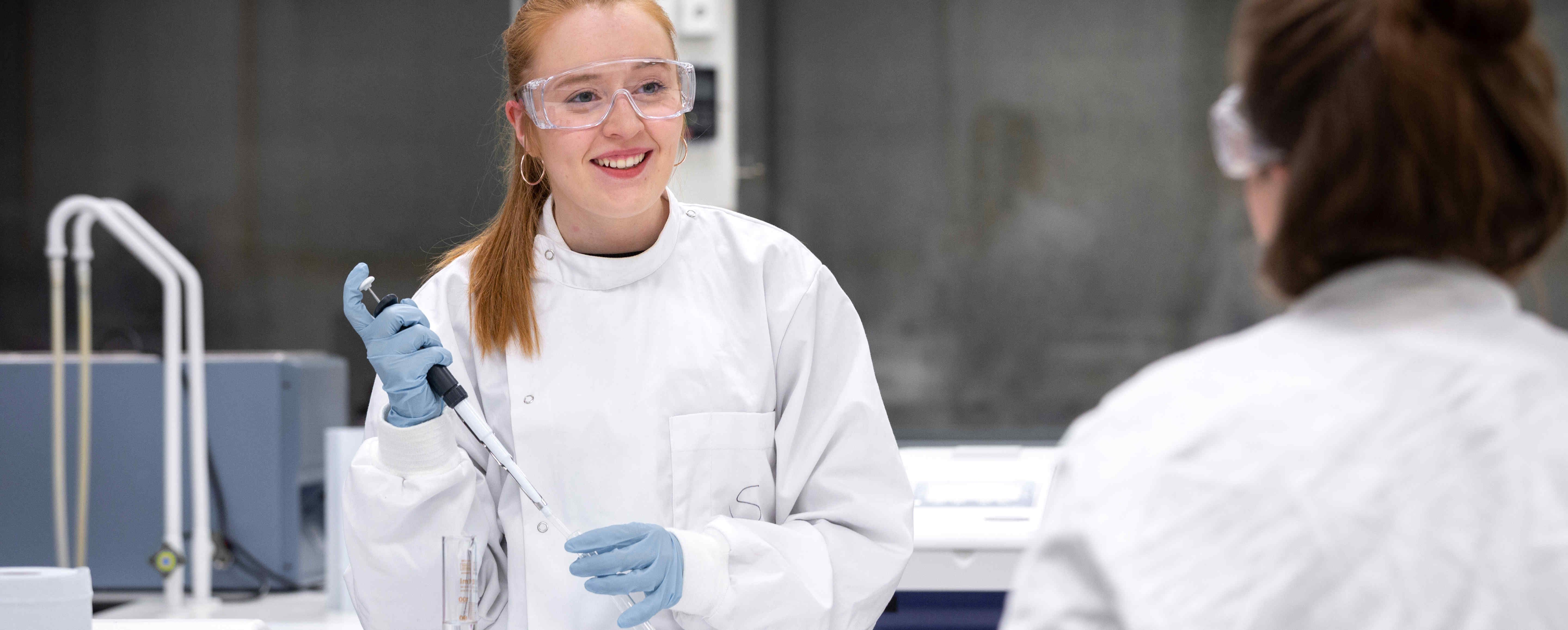Student smiling during bioengineering lab work