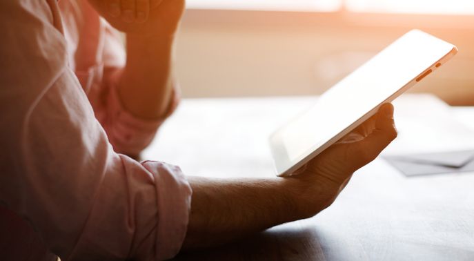 Image of a man holding an iPad