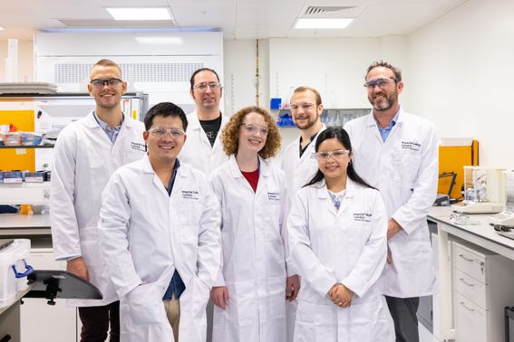 A group of researchers wearing lab coats
