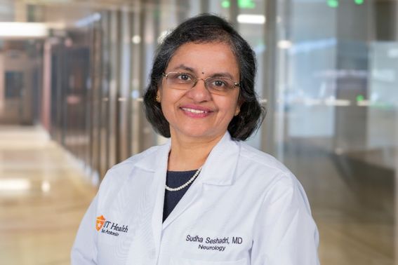 Headshot of Sudha Seshadri in white lab coat smiling