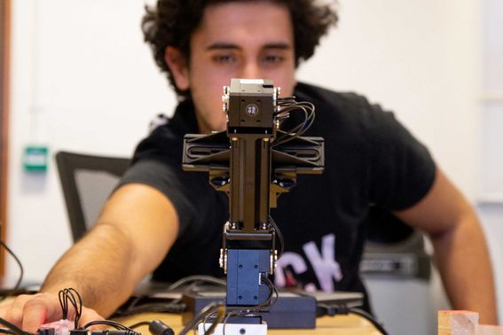 Student operates a robotic arm