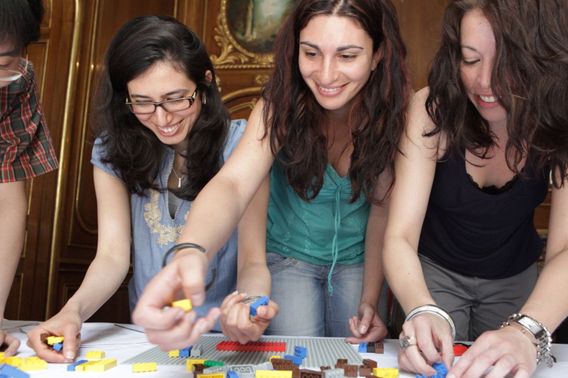 Students completing a team building chalange using lego