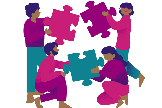 Four people holding large puzzle pieces