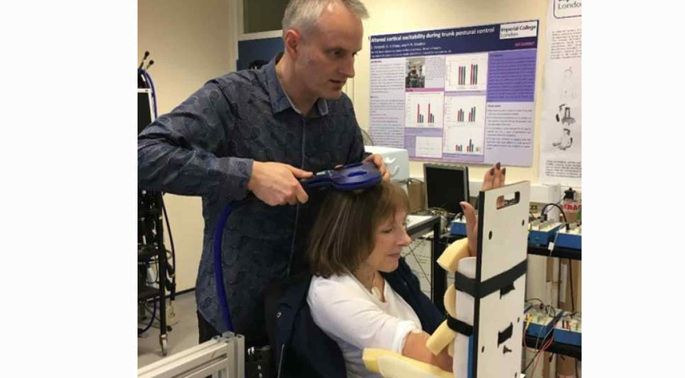 Principal Investigator Dr Paul Strutton applies a magnetic stimulus to the motor area of the brain controlling the trunk