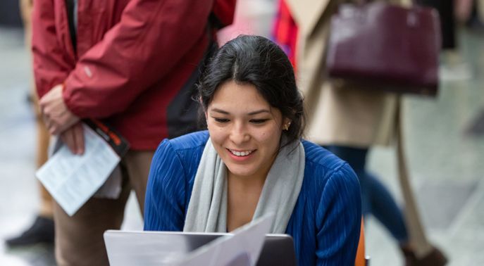 Woman smiling at laptop