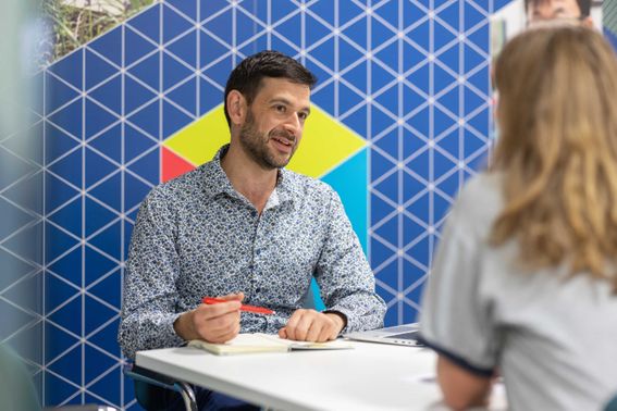 A student talking to a member of the Student Financial support team