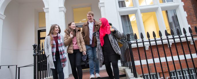 Students walking down steps outside halls