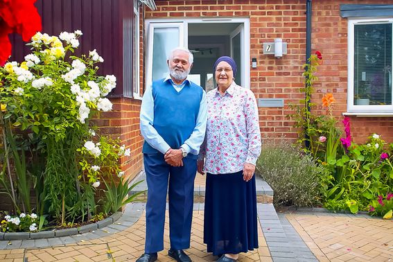 A couple stood outside their front door