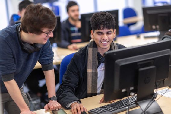 Student and Teacher in computer room
