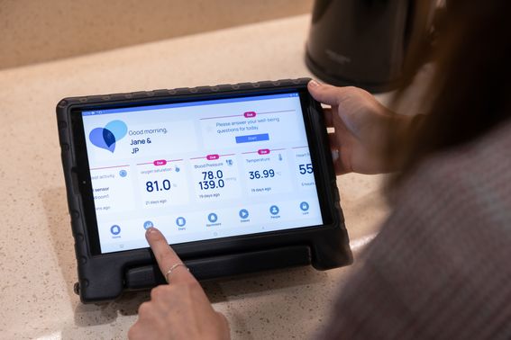 Image of health app showing on an iPad with a person's hand hovering over the screen