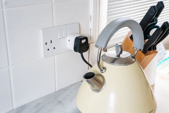 Image of a smart plug sensor attached to the plug of a kettle